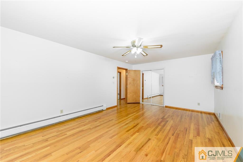 111 Greymoor Road Howell, NJ 07731 - Photo 10 of 25 a view of an empty room with wooden floor