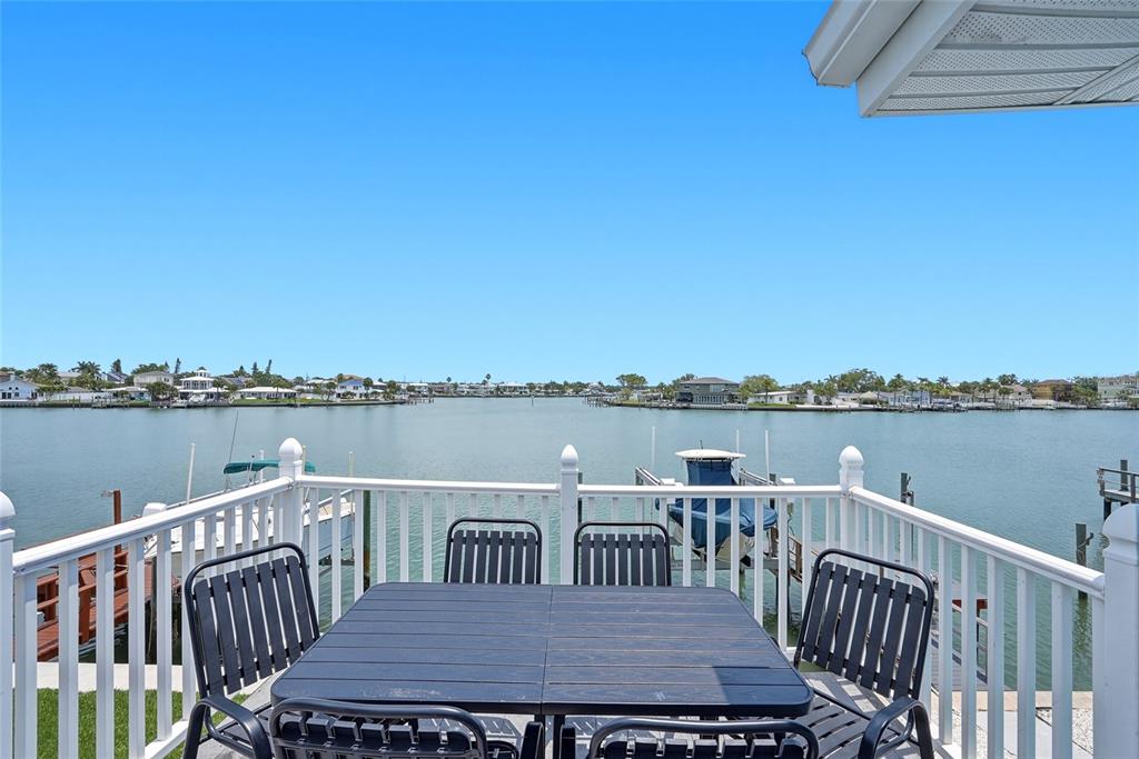 2311 Bay Boulevard Indian Rocks Beach, FL 33785 - Photo 12 of 80 a view of a deck with two chairs and a table