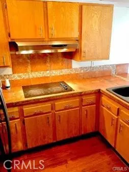 a view of a room with wooden floor and cabinet