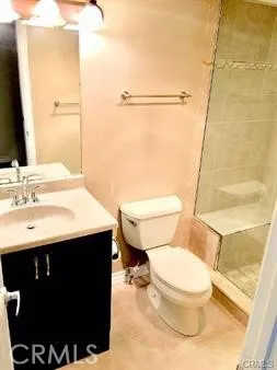 a bathroom with a sink vanity mirror and toilet
