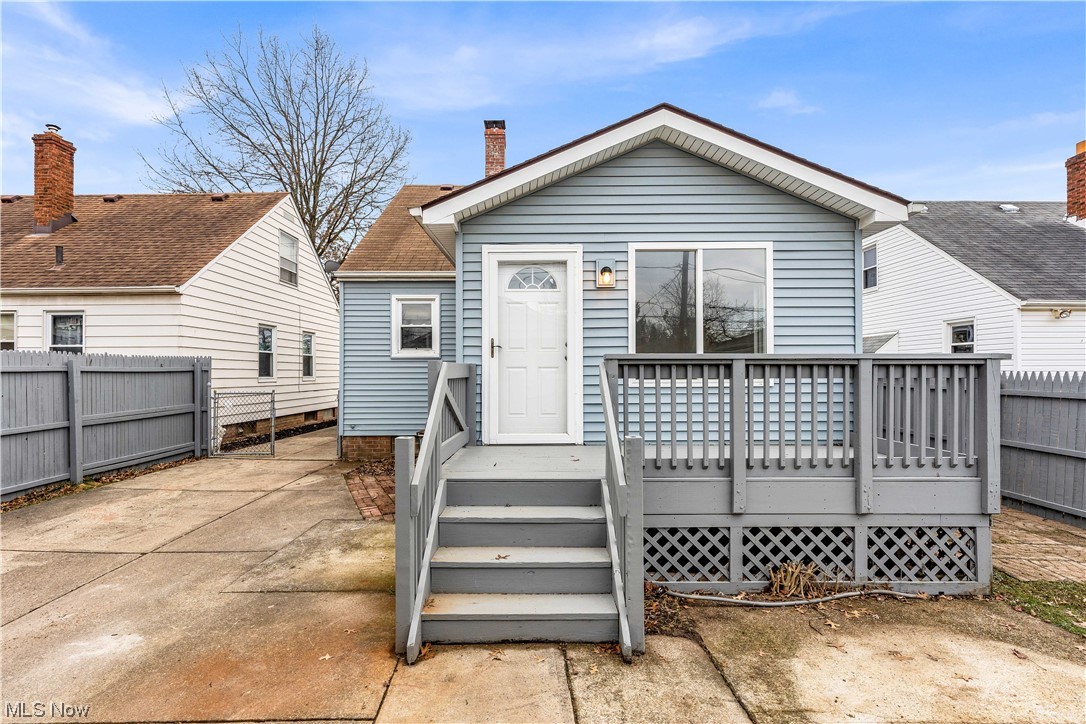 Back of property featuring a deck and a patio