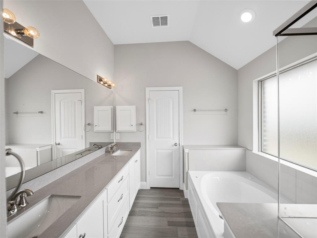 302 Pennington Road Josephine, TX 75173 - Photo 14 of 24 a spacious bathroom with a tub sink and mirror