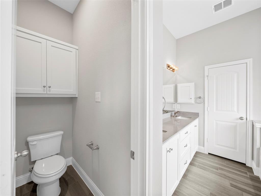 302 Pennington Road Josephine, TX 75173 - Photo 16 of 24 a bathroom with a granite countertop sink toilet and vanity