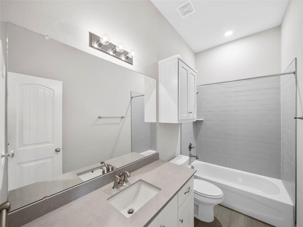 302 Pennington Road Josephine, TX 75173 - Photo 19 of 24 a bathroom with a sink toilet a mirror and shower