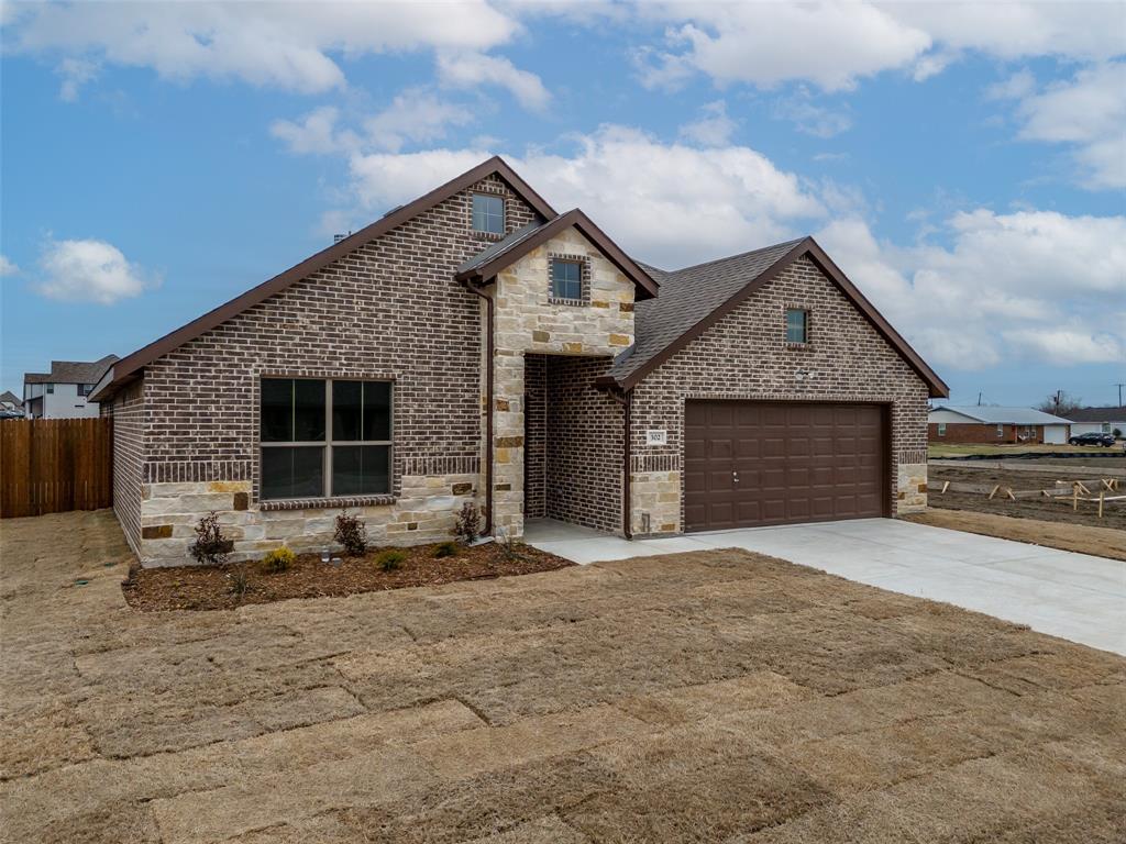 302 Pennington Road Josephine, TX 75173 - Photo 2 of 24 a front view of a house with a yard and garage