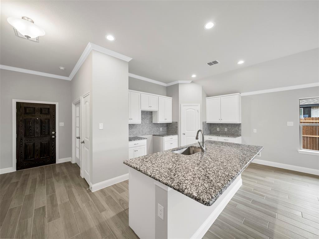 302 Pennington Road Josephine, TX 75173 - Photo 5 of 24 a kitchen with kitchen island a counter top space a sink stainless steel appliances and cabinets