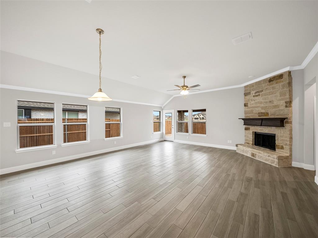 302 Pennington Road Josephine, TX 75173 - Photo 7 of 24 a view of empty room with wooden floor and fireplace