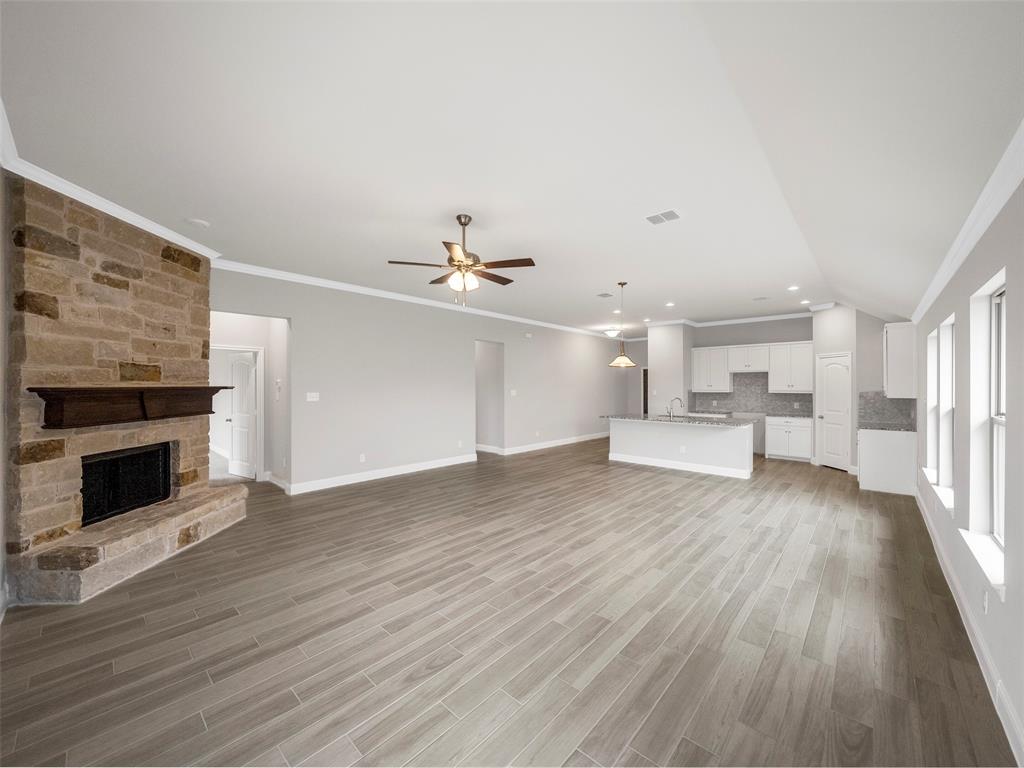 302 Pennington Road Josephine, TX 75173 - Photo 9 of 24 a view of an empty room with wooden floor fireplace and a window