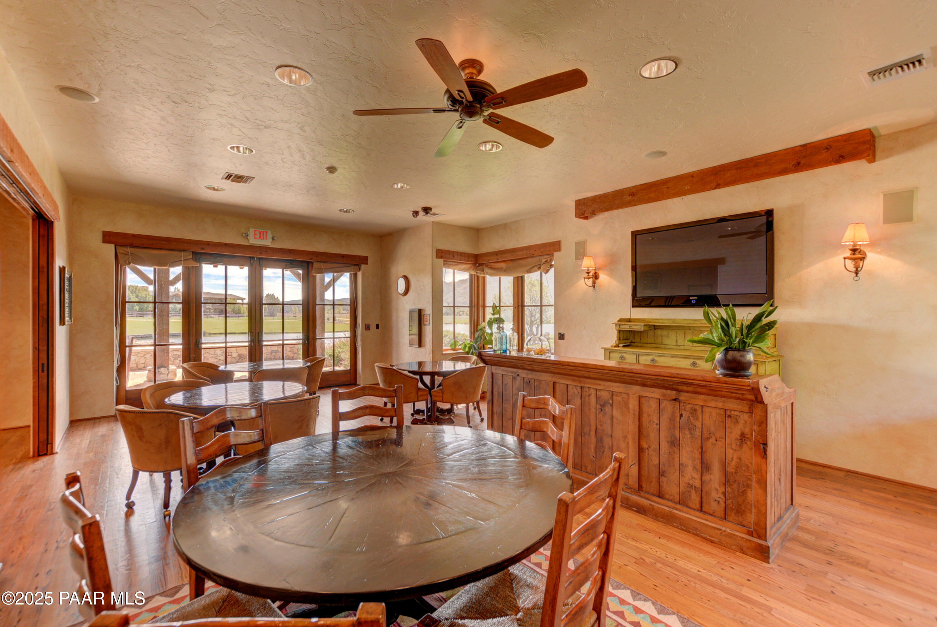 9875 North Equine Road Prescott, AZ 86305 - Photo 15 of 24 a dining room with furniture a flat screen tv and a large window