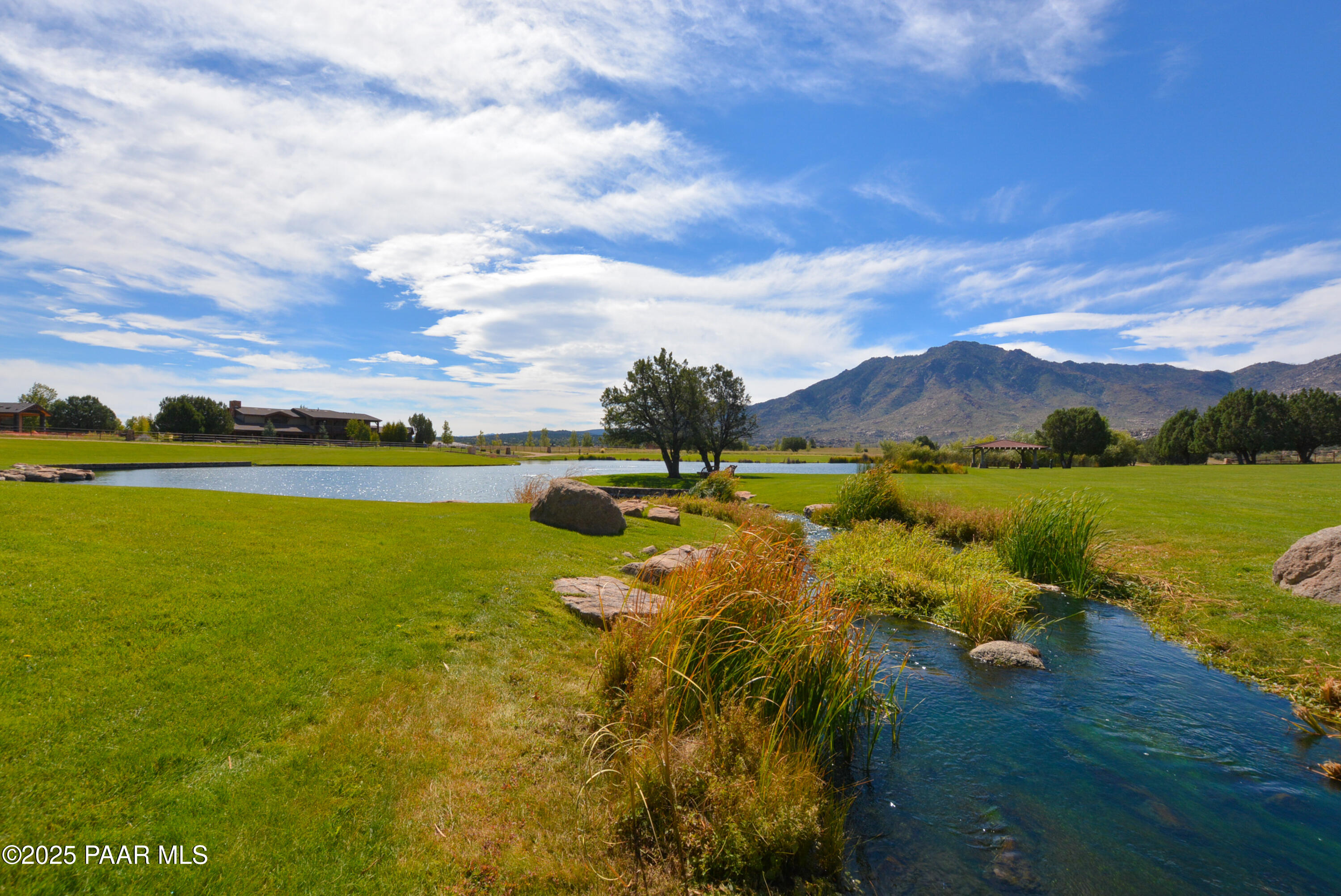 9875 North Equine Road Prescott, AZ 86305 - Photo 20 of 24 a view of a lake with houses in the back