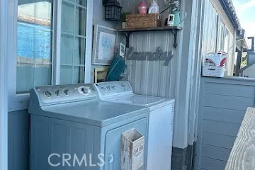 a living room with furniture kitchen view and a refrigerator