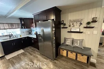 a kitchen with kitchen island a dining table chairs and a refrigerator