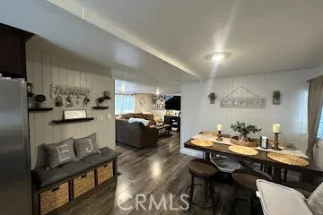 a living room with furniture a flat screen tv and a wall clock
