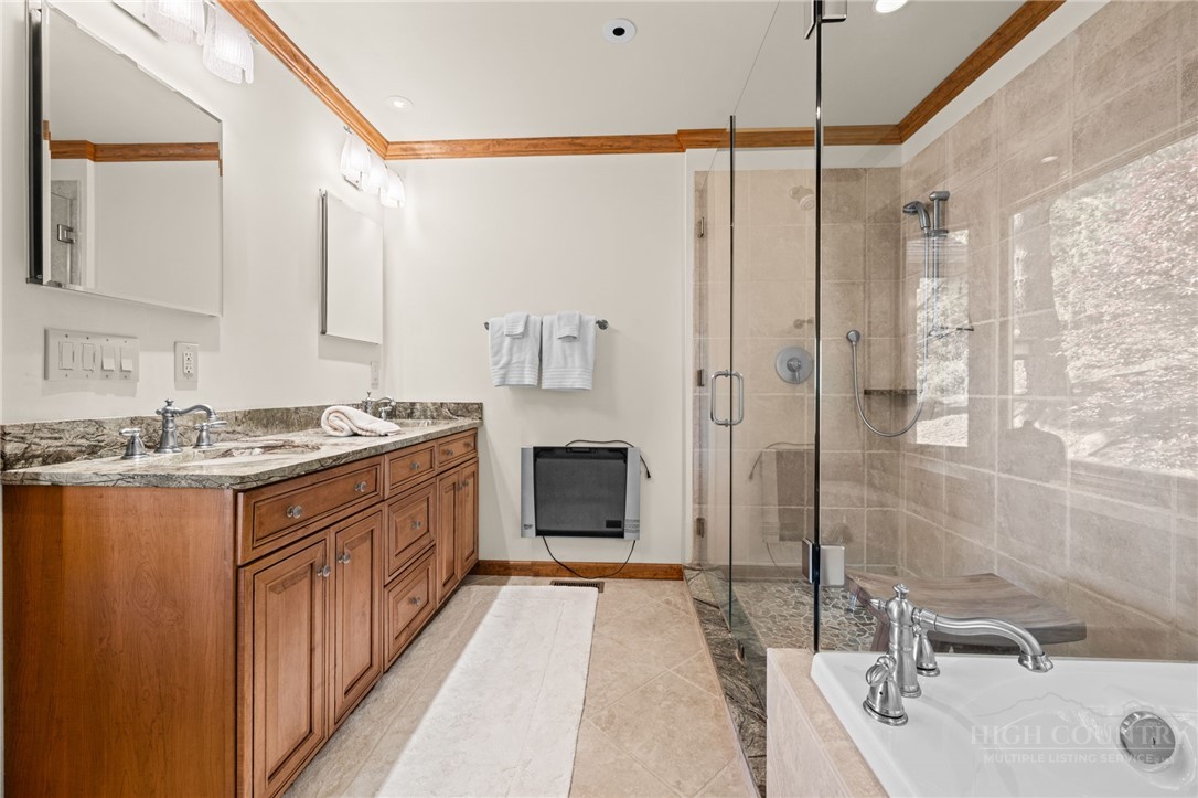 331 Alpine Road Blowing Rock, NC 28605 - Photo 27 of 50 a bathroom with a sink double vanity and a shower