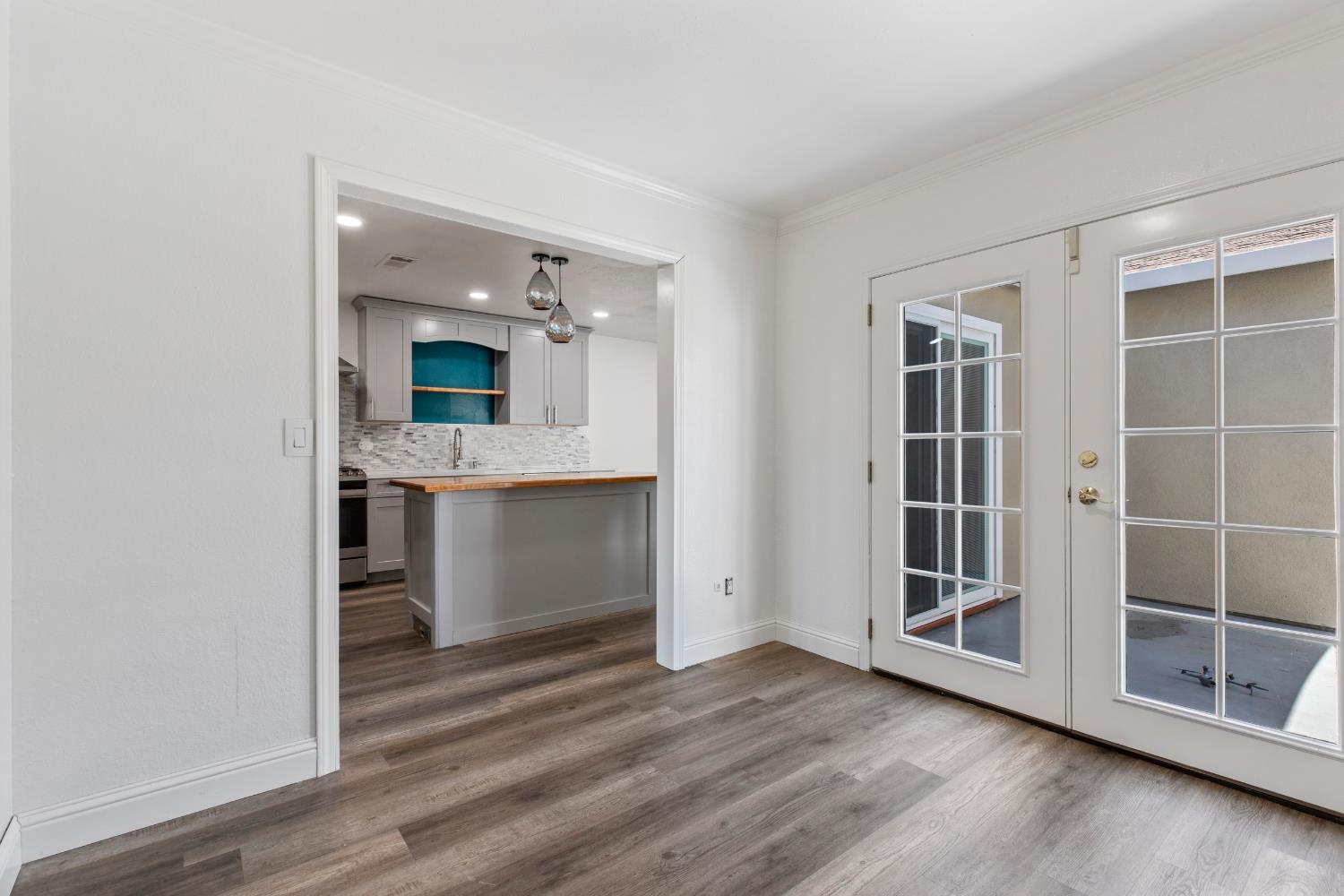 4005 Goldust Drive Modesto, CA 95355 - Photo 11 of 36 an empty room with wooden floor and cabinet