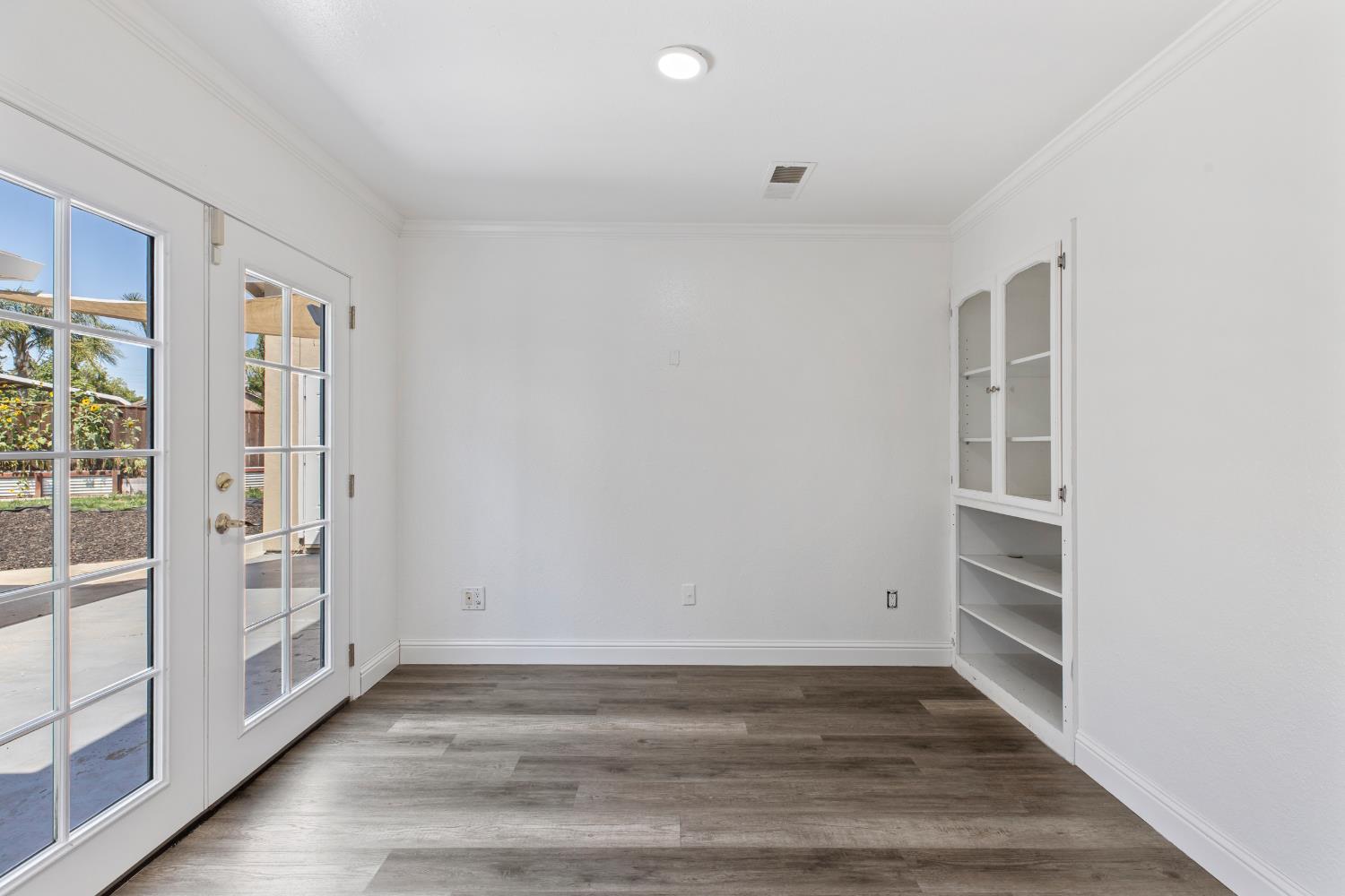 4005 Goldust Drive Modesto, CA 95355 - Photo 14 of 36 a view of an empty room with wooden floor and a window
