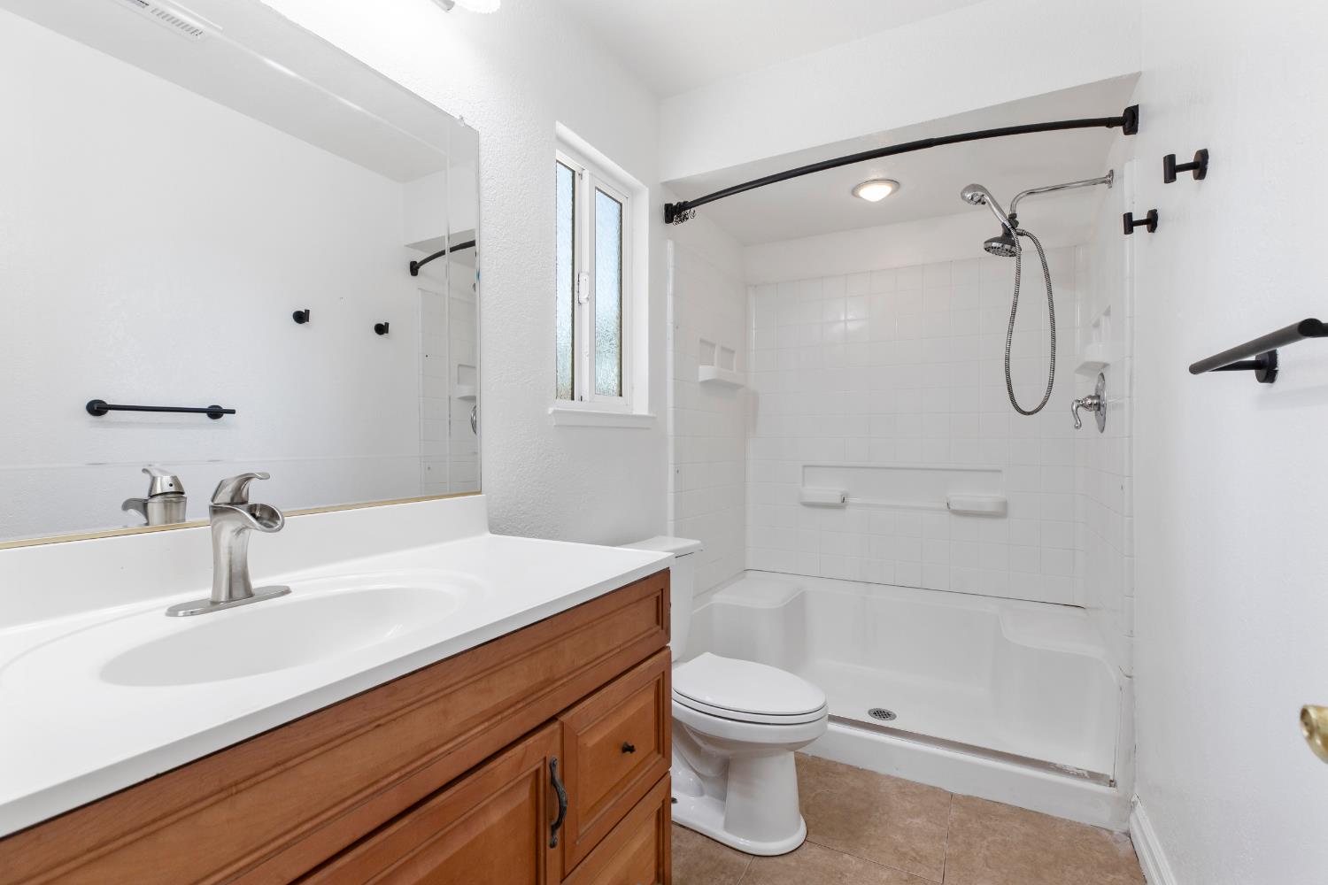 4005 Goldust Drive Modesto, CA 95355 - Photo 19 of 36 a bathroom with a sink a toilet and shower