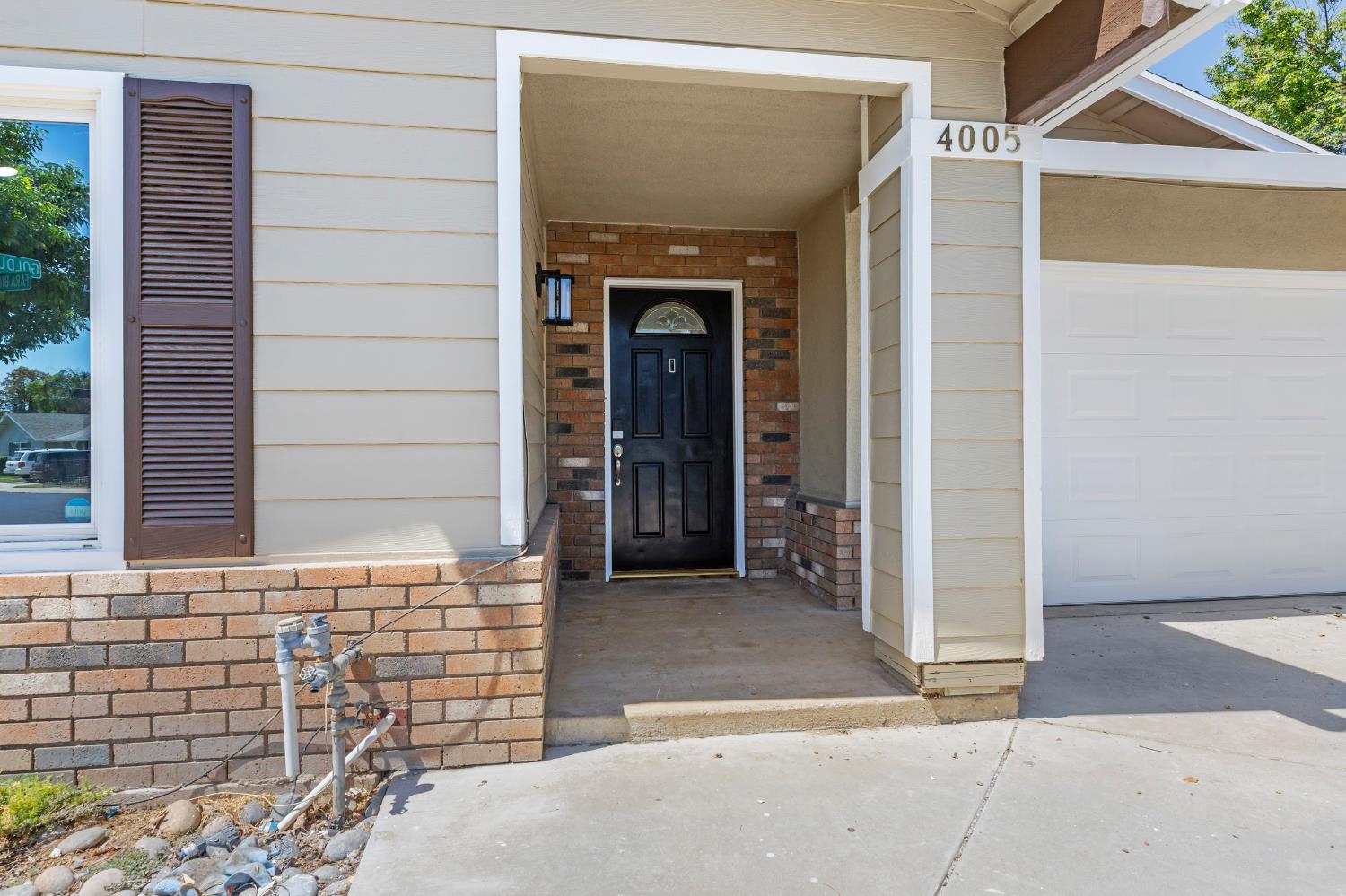4005 Goldust Drive Modesto, CA 95355 - Photo 3 of 36 front view of a brick house with a large windows