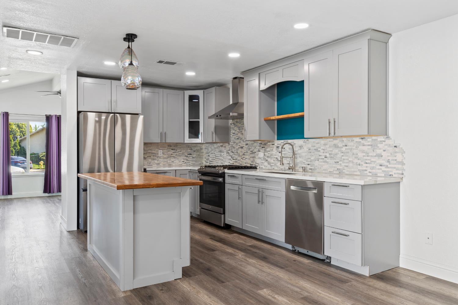 4005 Goldust Drive Modesto, CA 95355 - Photo 8 of 36 a kitchen with stainless steel appliances granite countertop a sink stove and refrigerator