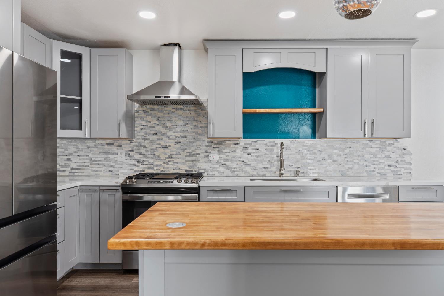 4005 Goldust Drive Modesto, CA 95355 - Photo 9 of 36 a kitchen with a sink and a refrigerator