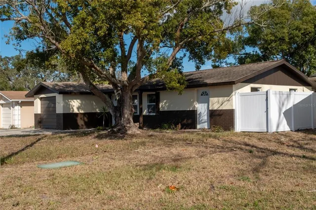 a view of a house with a snow in the yard