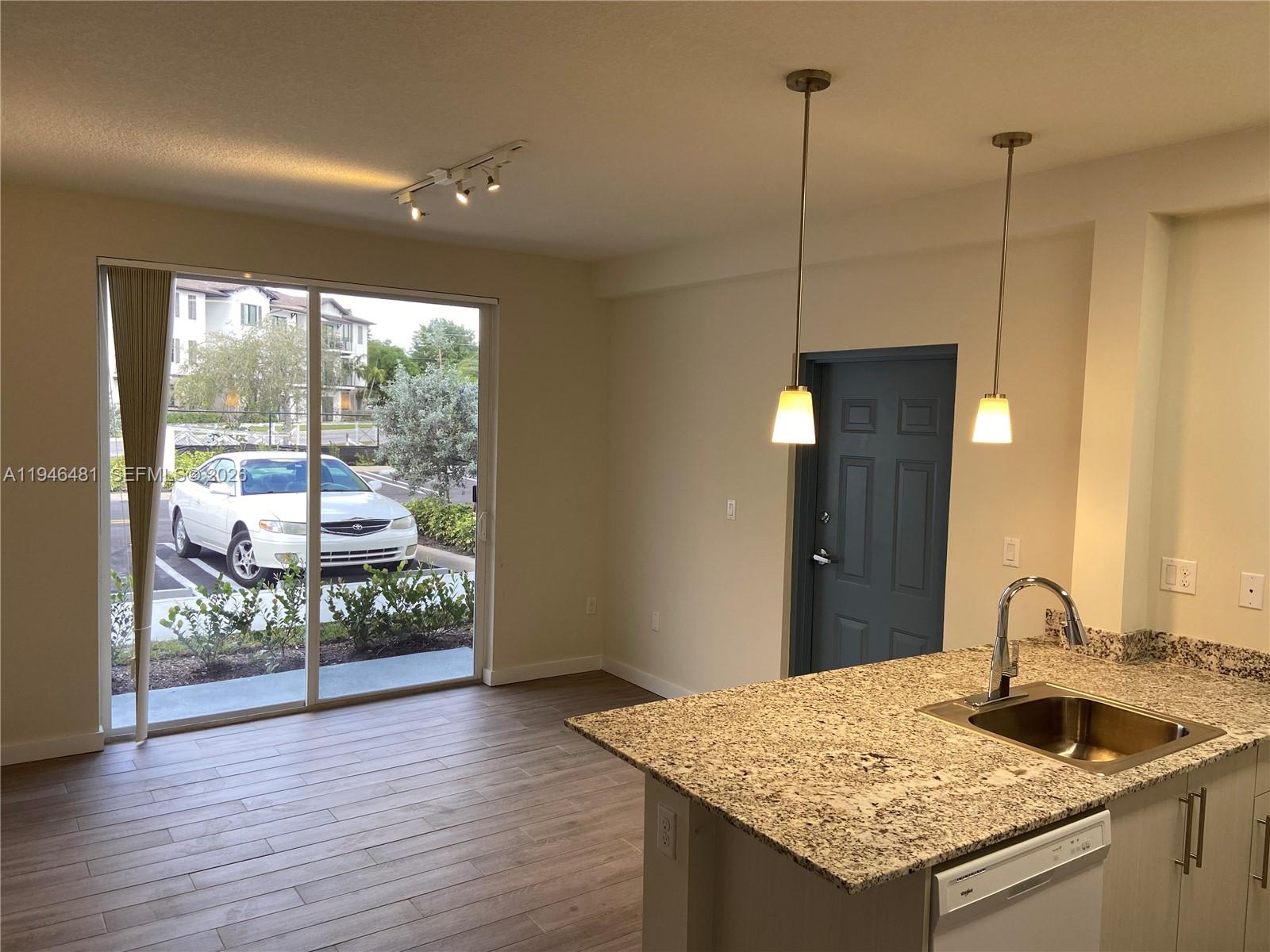 26511 Southwest 146th Court, Unit 316 Homestead, FL 33032 - Photo 4 of 6 a kitchen with a table and chairs