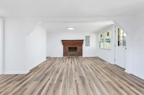 a view of a hallway with wooden floor