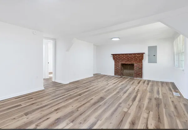a view of a room with wooden floor