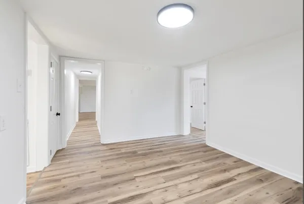 a view of kitchen and empty room