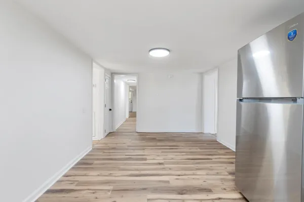 a view of entryway and hall with wooden floor