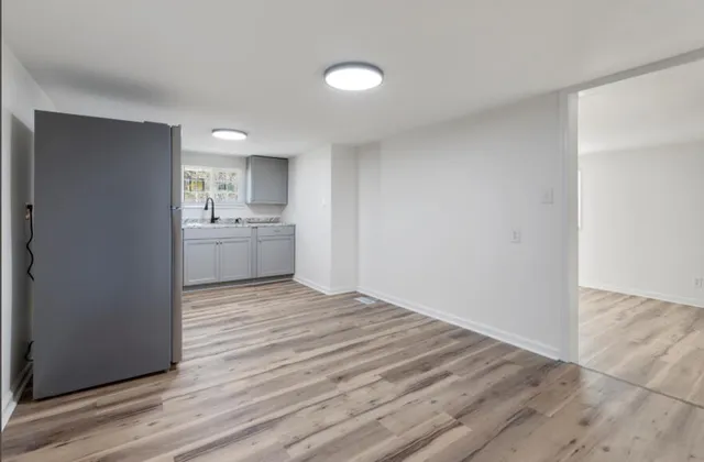 a view of an empty room and wooden floor