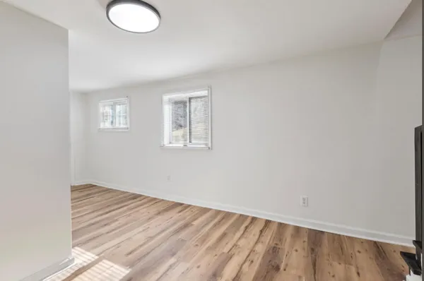 a view of an empty room and wooden floor