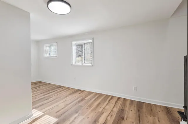 wooden floor in an empty room with a window