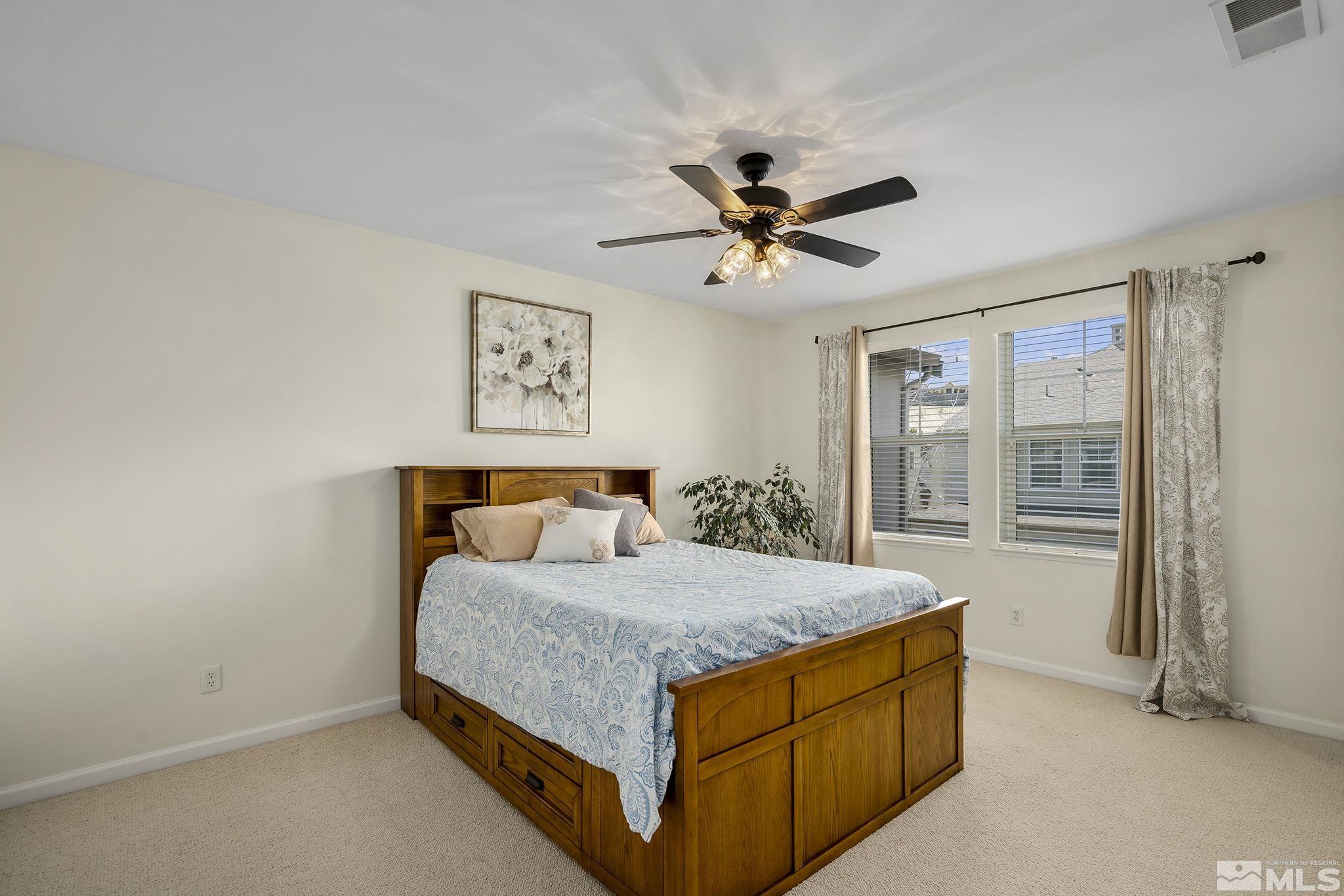 1618 Spring Hill Drive Reno, NV 89523 - Photo 14 of 25 a bedroom with a bed and large windows
