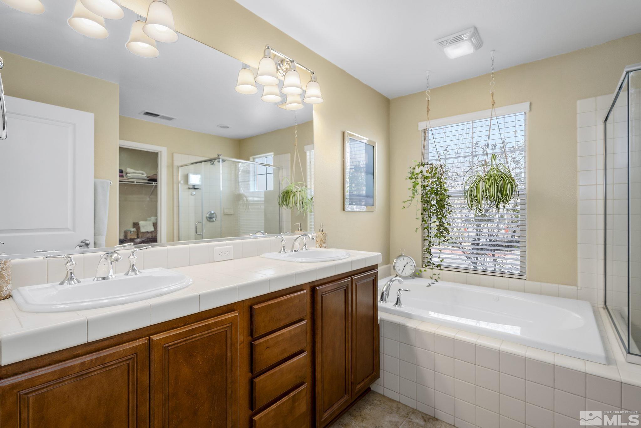 1618 Spring Hill Drive Reno, NV 89523 - Photo 15 of 25 a bathroom with a granite countertop sink mirror bathtub and shower