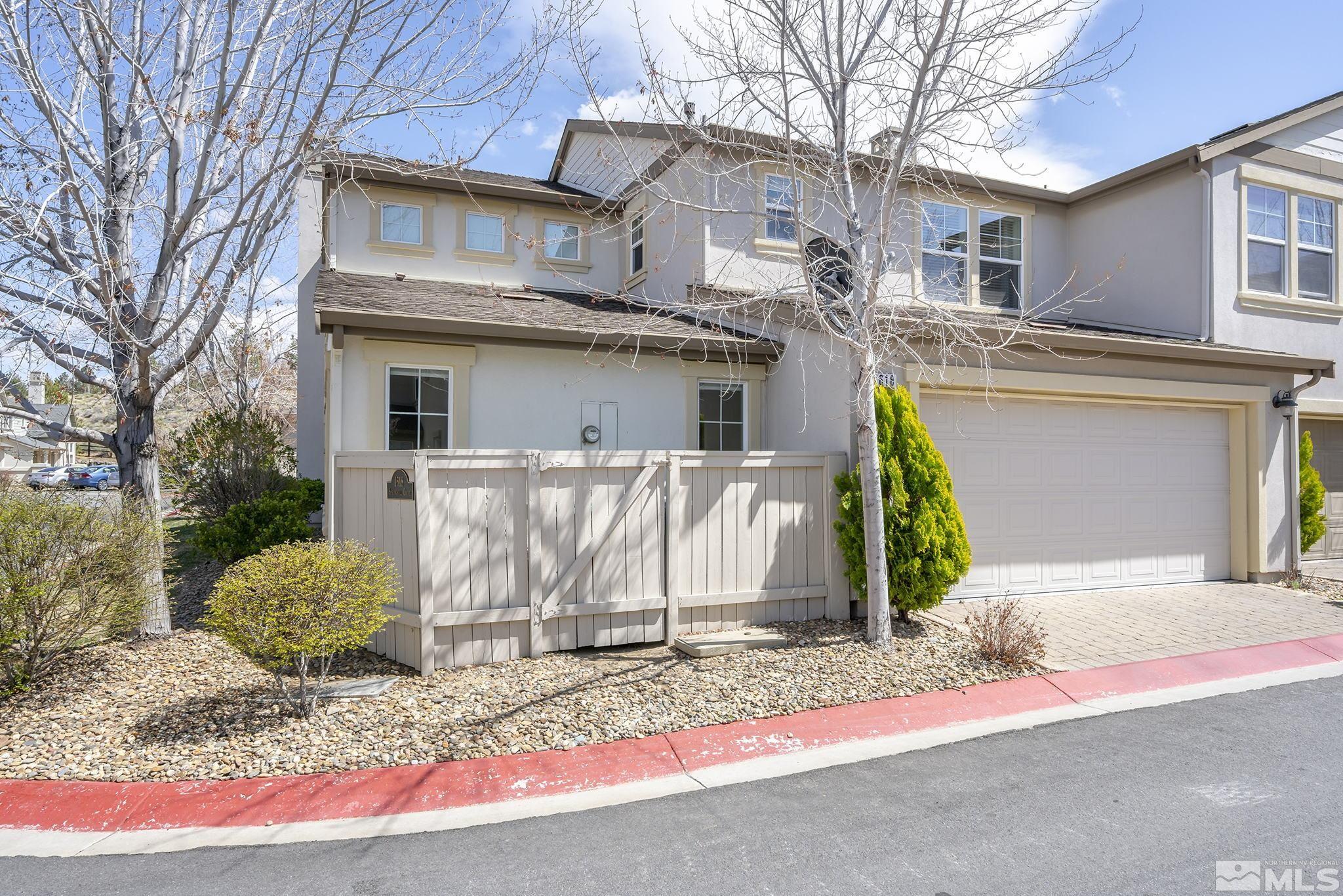 1618 Spring Hill Drive Reno, NV 89523 - Photo 23 of 25 a front view of a house with a yard and garage