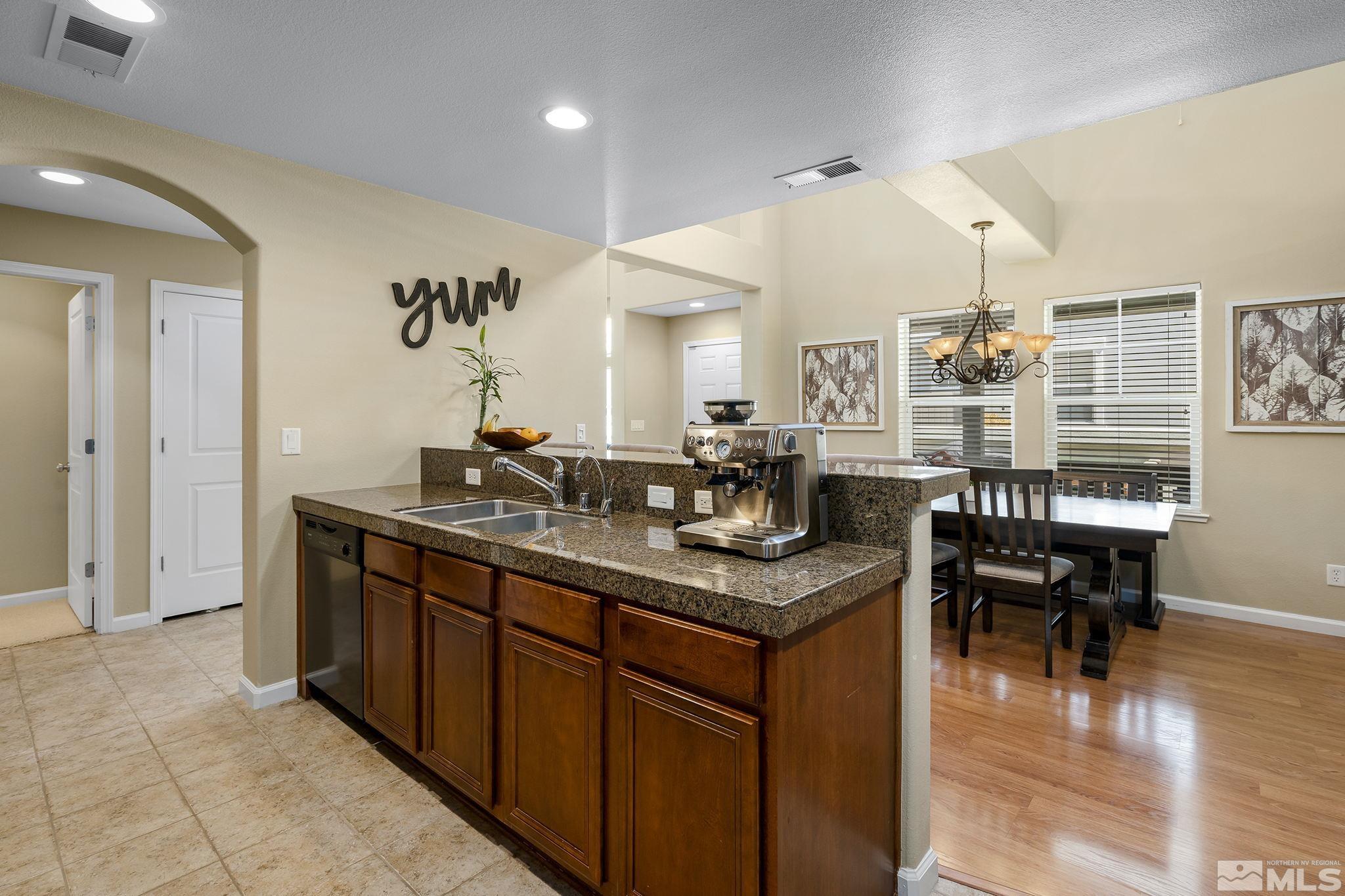 1618 Spring Hill Drive Reno, NV 89523 - Photo 7 of 25 a kitchen with granite countertop a sink and cabinets