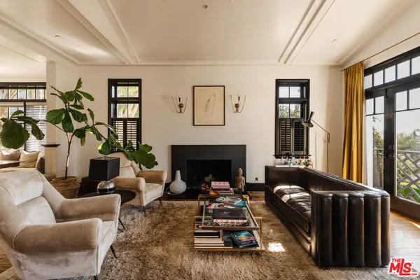 a living room with furniture windows and a fireplace