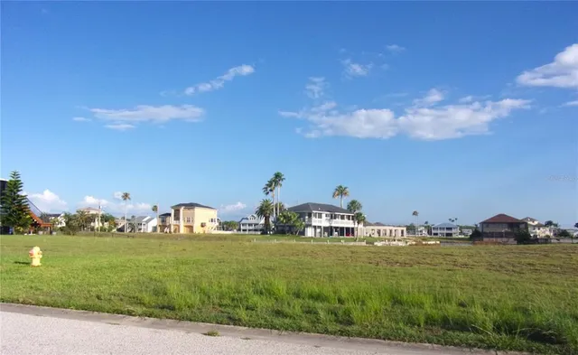 a view of white house with a big yard