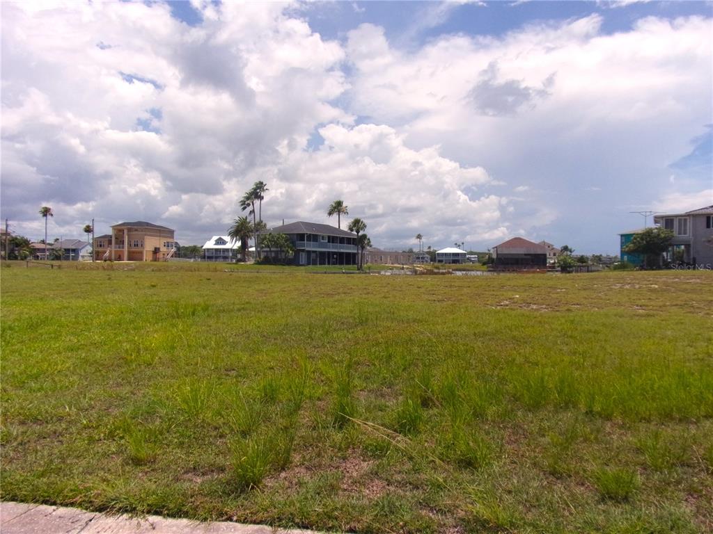 3406 Bluefish Drive Hernando Beach, FL 34607 - Photo 6 of 10 a view of a lake with houses in the back