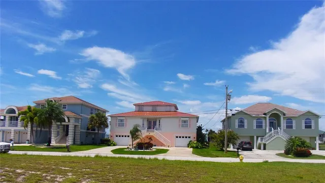 a front view of a house with a garden and plants