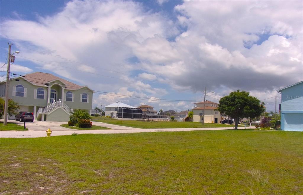 3406 Bluefish Drive Hernando Beach, FL 34607 - Photo 9 of 10 a view of a swimming pool with a yard in front of it