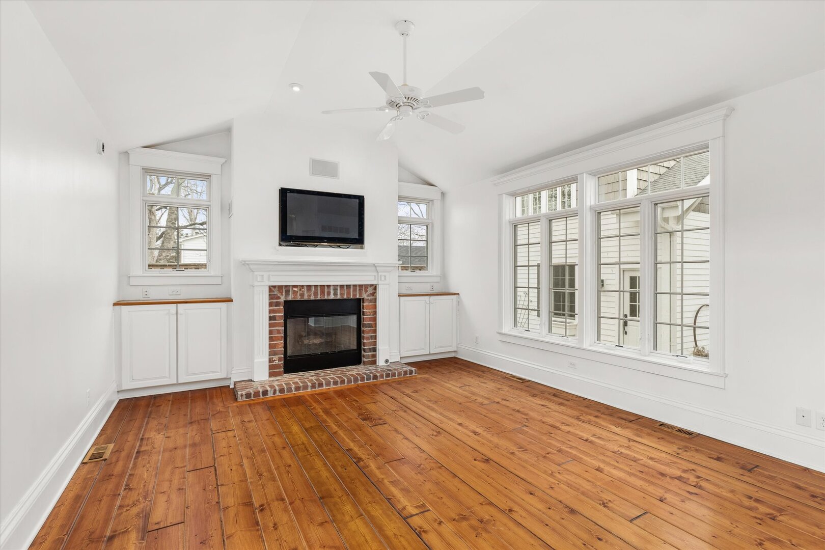 540 Pearl Street Ottawa, IL 61350 - Photo 22 of 70 a view of an empty room with wooden floor fireplace and a window