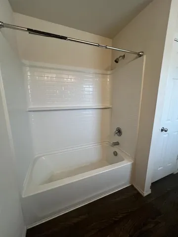 a bathroom with a bathtub and a shower