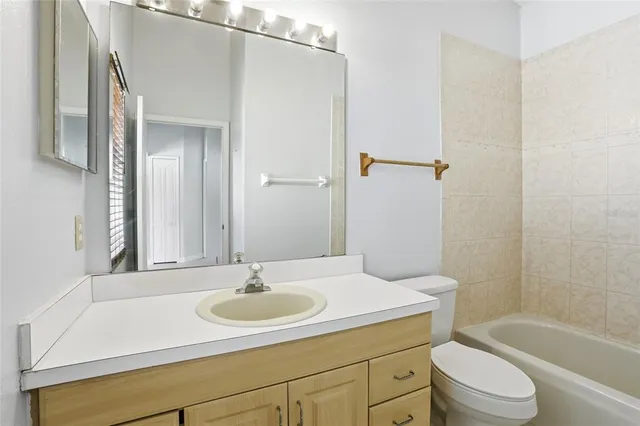 a bath tub sitting next to a white toilet