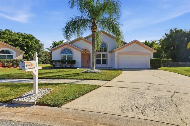 a front view of a house with a garden and yard