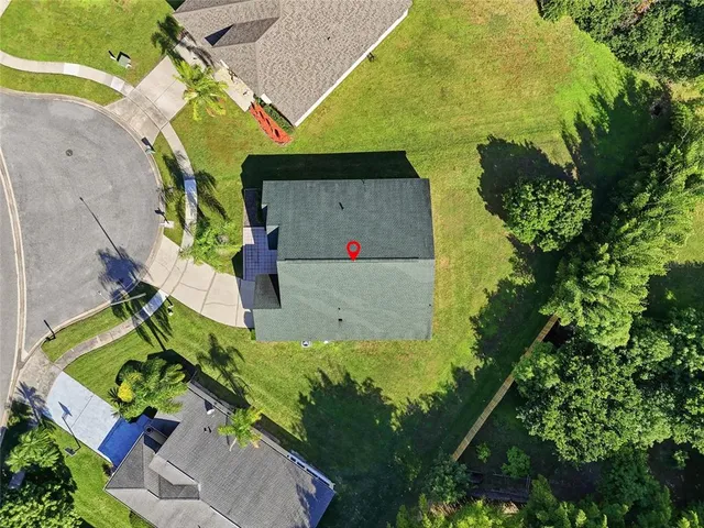 a aerial view of a house with a yard