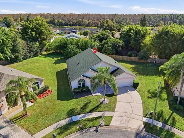 an aerial view of a house with garden space and outdoor seating