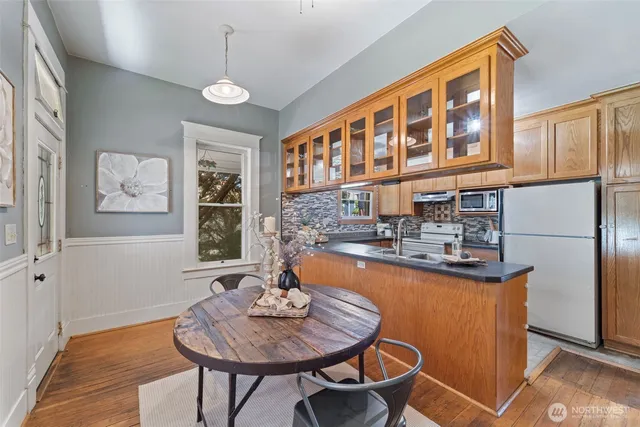 a dining room with furniture a chandelier and wooden floor