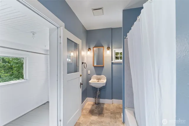 a bathroom with a sink and a mirror